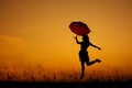 Umbrella woman jumping and sunset silhouette when she happy Royalty Free Stock Photo