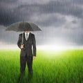 Umbrella woman standing to raincloud in grassland with umbrella