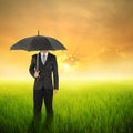 Umbrella woman standing to sunset in grassland with umbrella