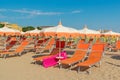 Umbrellas and chaise lounges on the beach of Rimini in Italy