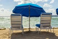 Umbrellas and empty beach couches Royalty Free Stock Photo