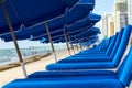 Umbrellas and empty beach couches Royalty Free Stock Photo