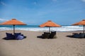 Umbrellas and empty bean bags on Berawa Beach, Bali, Indonesia Royalty Free Stock Photo