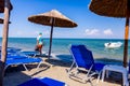 Umbrellas with loungers, chaise are placed next to the coastline, along water edge Royalty Free Stock Photo