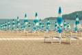 Umbrellas and loungers for relax and comfort on sea beach. Happy summer vacations and resort concept. Paid service on beaches