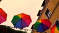 Umbrellas in rainbow colors above the street