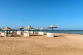 Umbrellas and sun loungers on an empty beach in Makadi Bay, which one of Egypt beautiful Red Sea Riviera Royalty Free Stock Photo