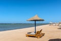 Umbrellas and sun loungers on an empty beach in Makadi Bay, which one of Egypt beautiful Red Sea Riviera Royalty Free Stock Photo