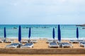 Umbrellas and sun loungers on the sandy beach at the beginning of the season. Ayia NAPA, Cyprus Royalty Free Stock Photo