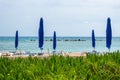 Umbrellas and sun loungers on the sandy beach at the beginning of the season. Ayia NAPA, Cyprus Royalty Free Stock Photo