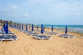 Umbrellas and sun loungers on the sandy beach at the beginning of the season. Ayia NAPA, Cyprus Royalty Free Stock Photo