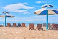 Umbrellas from the sun with seats on the lake. Royalty Free Stock Photo