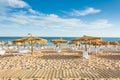 Umbrellas and sunbeds on the beach of Quarteira, Portugal, Algave Royalty Free Stock Photo