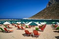 Umbrellas and sunbeds on the sandy beach in Stavros on the island of Crete