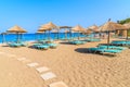 Umbrellas and sunbeds on sandy Potami beach, Samos island, Greece Royalty Free Stock Photo