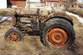 Old rusty tractor standing abandoned at the farm