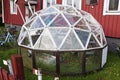 Spherical greenhouse stands on lawn in front of a townhouse