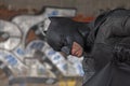 cosplayer dressed as Batman with graffiti in the background