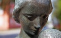 Face on statue, woman with child at Umedalen