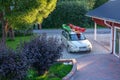 UMEA, SWEDEN - JUNE 1, 2021: An executive car with two mounted kayaks parked at private parking lot close to garage