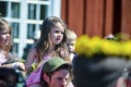 Beautiful swedish people and dissapointed kids are enjoying traditional decoration of mid summer day wearing colourful crown in