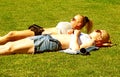 Two girls sunbathing in central park Royalty Free Stock Photo