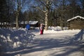 Umea, Sweden - March 07, 2020 Tranquil view of kids playing on the snowy road under the shadow of pine tree on untouched snow