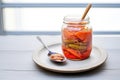 umeboshi in glass jar with pickling brine