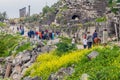 UMM QAIS, JORDAN - MARCH 30, 2017: Tourists visit the ruins of Umm Qa