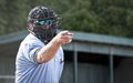 Umpire in blue uniform calls a strike Royalty Free Stock Photo