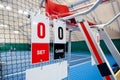 Umpire chair with scoreboard on a tennis court before the game. Royalty Free Stock Photo