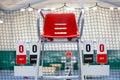 Umpire chair with scoreboard on a tennis court before the game. Royalty Free Stock Photo