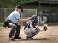 Umpire watches behind catcher as batter strikes Royalty Free Stock Photo