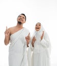 Umrah couple presenting copyspace