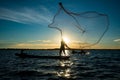 Un-identified silhouette fisher man on boat fishing by throwing Royalty Free Stock Photo