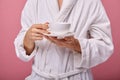 Sleepy young man with a cup of coffee in his hands