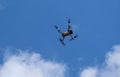 Un undefined air drone flying in the blue sky Royalty Free Stock Photo