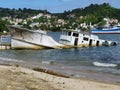 Sunken ship on the seashore. Barco hundido en la orilla del mar. Royalty Free Stock Photo