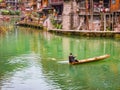 :Unacquainted local chinese people on the boat in fenghuang old town