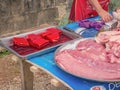 Unacquainted local people open the stall and selling raw pork on the road at vangvieng downtown in the the morning