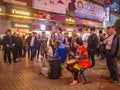 Unacquainted street performers singing and wearing traditional tribe shirt at huangxing walking street in Changsha city China