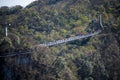 Unacquainted tourist walking on Suspension bridge cross the mountain at tianmen mountain Zhangjiajie china.Tianmen mountains