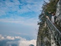 Unacquainted Tourists on Glass Cliff walk in tianmen mountain at Zhangjiajie city china. Royalty Free Stock Photo