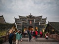 Unacquainted toursit walk on the bridge cross the river of fenghuang old town.