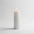 Unadorned white pillar candle is placed against a plain light Royalty Free Stock Photo