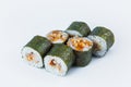 Unagi Maki Roll with eel and rice wrapped in nori seaweed, served with sauce and sesame seeds on light background Royalty Free Stock Photo