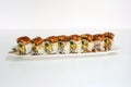 Unagi smoked filled avocado, tamago, kani, cucumber pickle sushi roll with teriyaki sauce