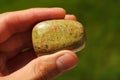 Unakite granite rock from India held in a hand Royalty Free Stock Photo