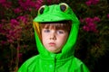 Unamused Boy in Frog Raincoat Looks at Camera