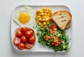 Unappetizing lunch on a white tray. Unappealing school or hospital meal with fried egg and vegetables. Generative AI Royalty Free Stock Photo